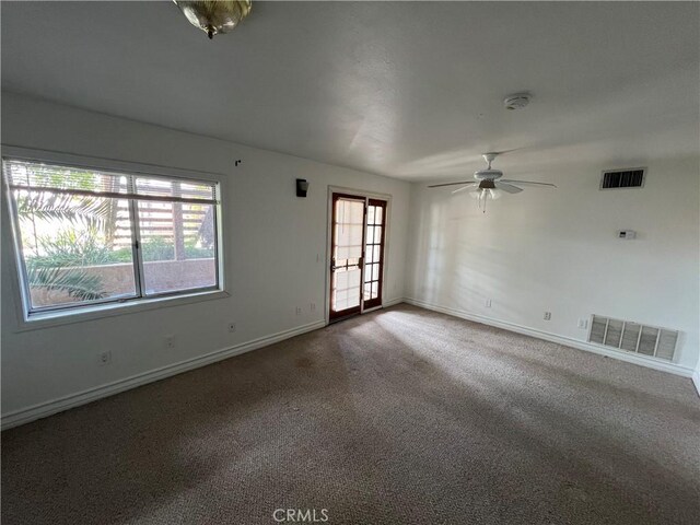 23029 Gray Fox Dr, Canyon Lake, CA 92587 - carpeted empty room featuring healthy amount of natural light, ceiling fan, baseboards, and a smoke detector