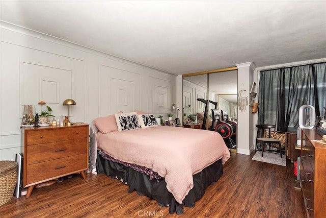 12113 Beverly Blvd Unit A, Whittier, CA 90601 - bedroom with dark wood-type flooring, a closet, and a decorative wall