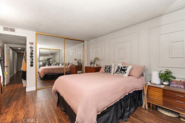 12113 Beverly Blvd Unit A, Whittier, CA 90601 - bedroom featuring a closet, dark wood-type flooring, and a decorative wall
