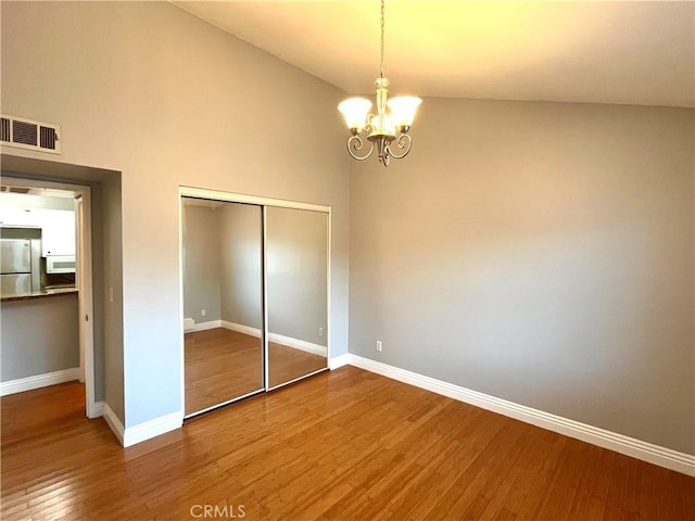 15000 Downey Ave Unit 204, Paramount, CA 90723 - unfurnished bedroom featuring freestanding refrigerator, a closet, wood finished floors, and baseboards