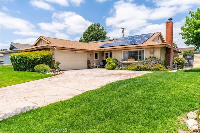 19264 Casmalia St, Rialto, CA 92377 - ranch-style house featuring a garage, a chimney, roof mounted solar panels, and a front yard