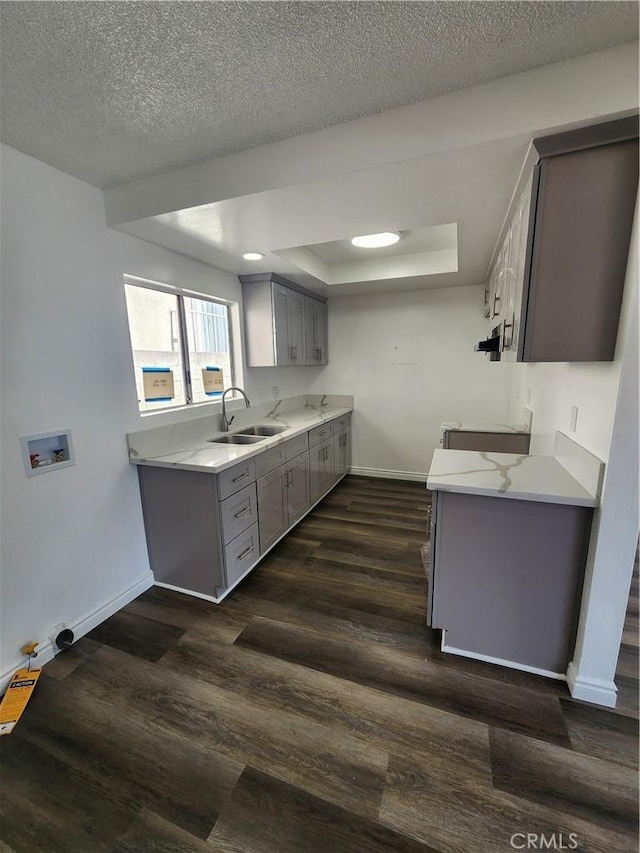 1451 W 146th St, Gardena, CA 90247 - kitchen featuring a sink, gray cabinets, baseboards, light countertops, and a textured ceiling