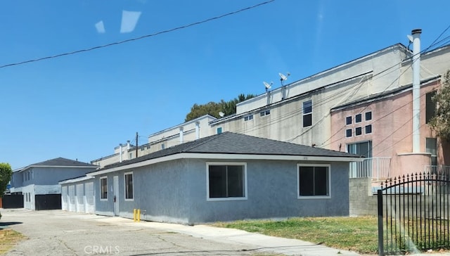 1451 W 146th St, Gardena, CA 90247 - view of side of property with stucco siding and roof with shingles