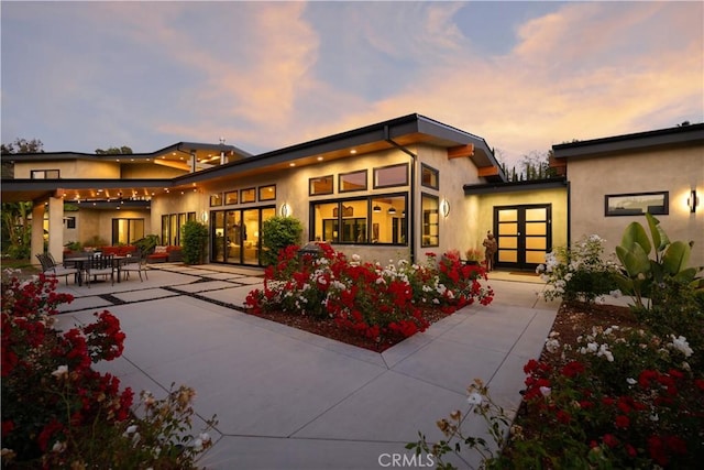 1088 Via Conca Doro, Vista, CA 92084 - back of house at dusk featuring a patio, stucco siding, and french doors