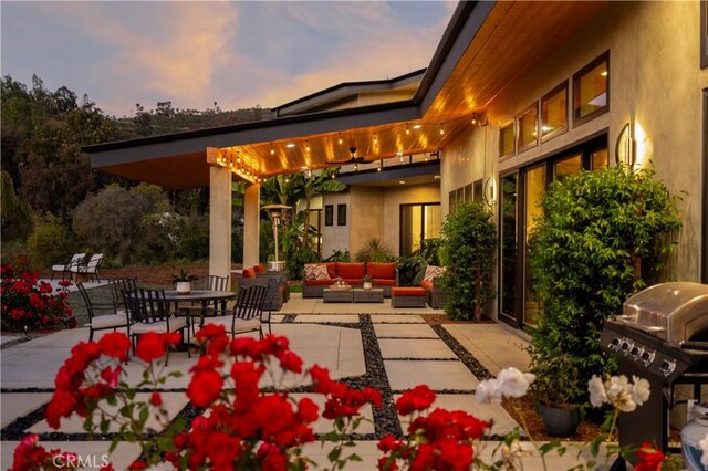 1088 Via Conca Doro, Vista, CA 92084 - patio terrace at dusk with an outdoor hangout area, a patio, and grilling area