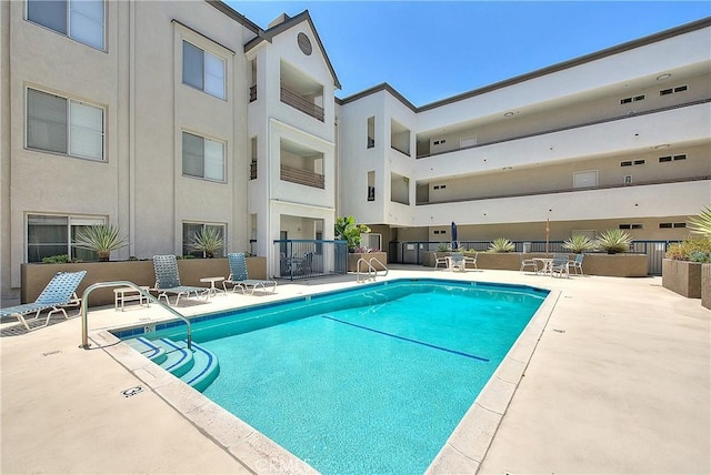 community pool with a patio area