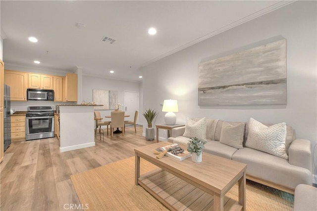 living room with crown molding, recessed lighting, and light wood-type flooring