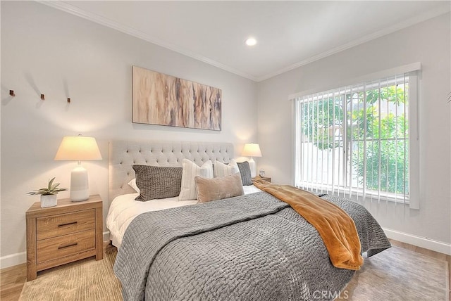 bedroom with baseboards, light wood finished floors, ornamental molding, and recessed lighting