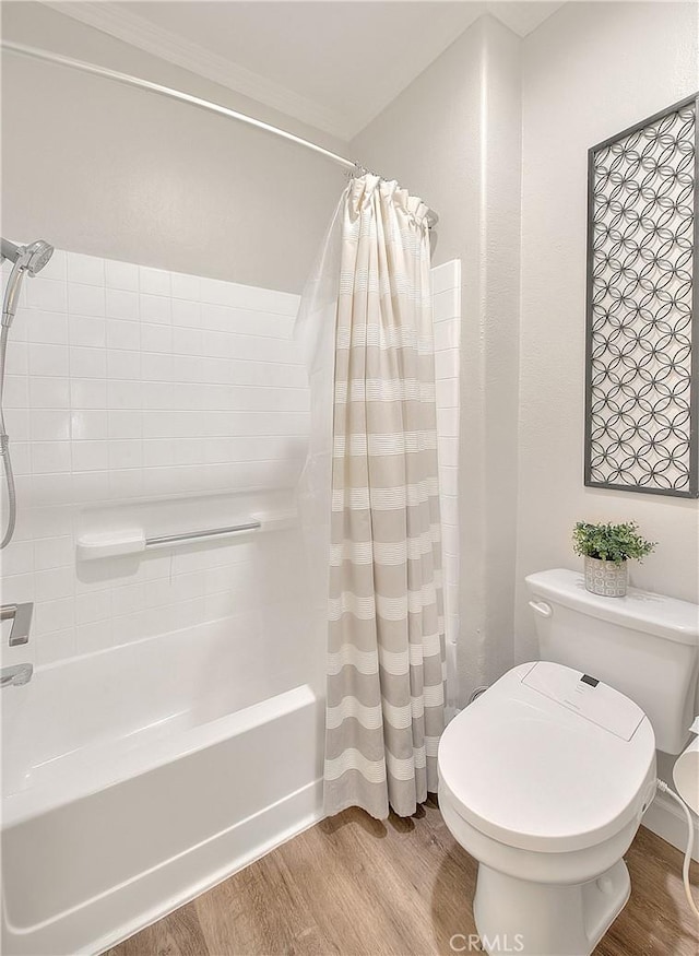 full bathroom with wood finished floors, toilet, and shower / tub combo with curtain
