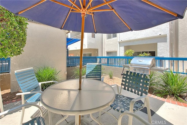view of patio / terrace featuring outdoor dining space and grilling area
