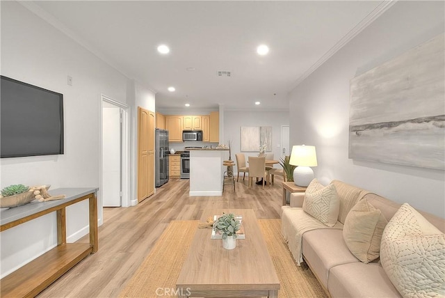 living area with recessed lighting, crown molding, and light wood finished floors