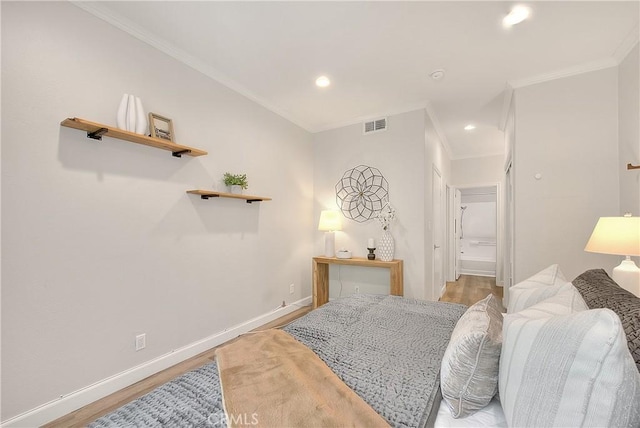 bedroom featuring wood finished floors, ornamental molding, baseboards, and recessed lighting