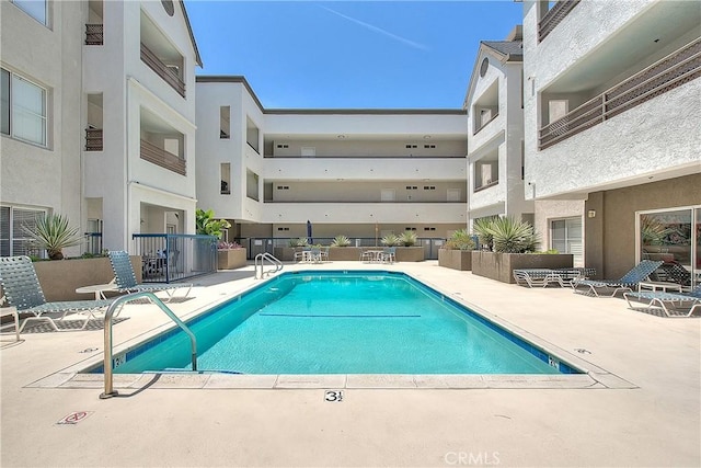 community pool featuring a patio area