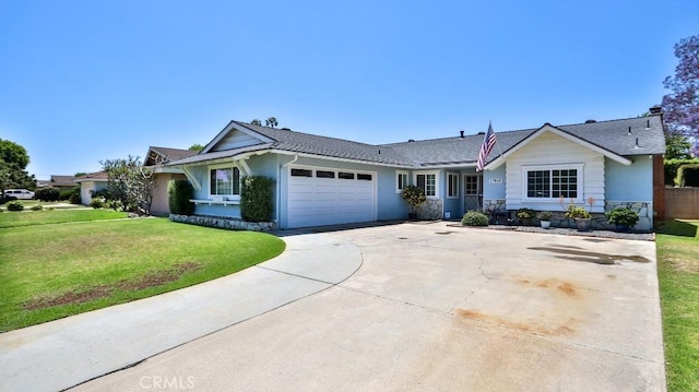 single story home with a garage, a front yard, driveway, a shingled roof, and stucco siding