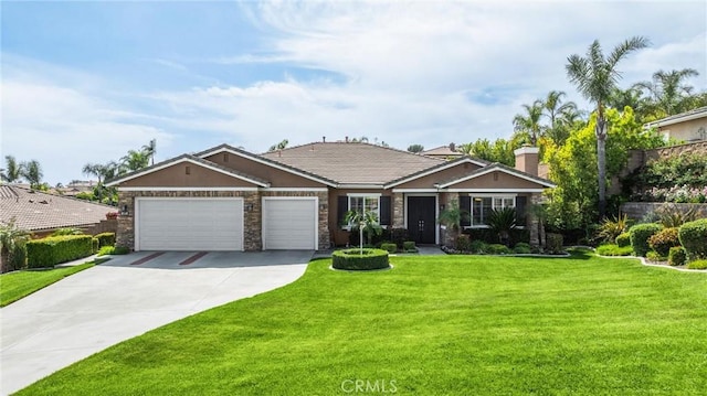 view of front facade with an attached garage, concrete driveway, a front yard, and stucco siding