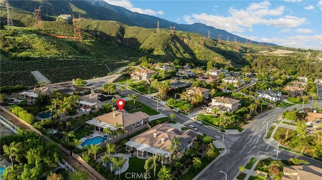 4976 Huntswood Pl, Rancho Cucamonga, CA 91737 - aerial overview of property's location featuring a mountain backdrop and nearby suburban area