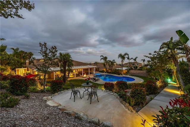 outdoor pool with a patio area