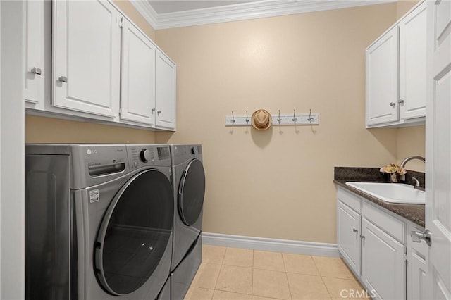 laundry area with cabinet space, washer and clothes dryer, baseboards, ornamental molding, and light tile patterned floors