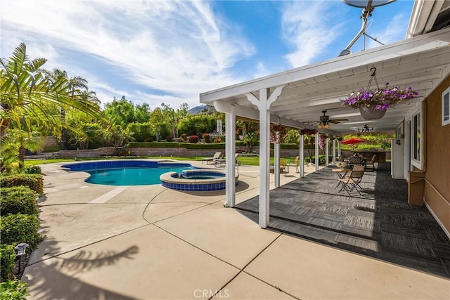 view of swimming pool featuring a patio, a ceiling fan, and a pool with connected hot tub