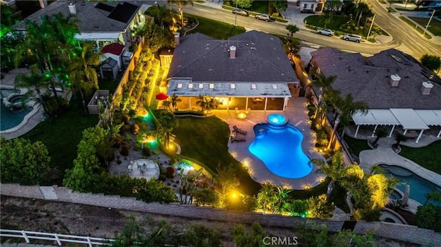 aerial view of property and surrounding area featuring a pool