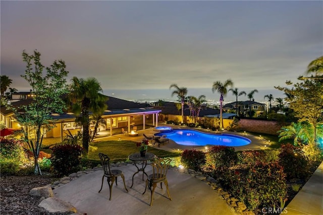 view of pool with a patio area, a fenced backyard, and a pool with connected hot tub