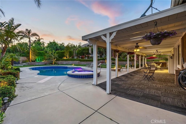 4976 Huntswood Pl, Rancho Cucamonga, CA 91737 - pool at dusk with a patio area, a ceiling fan, and a pool with connected hot tub