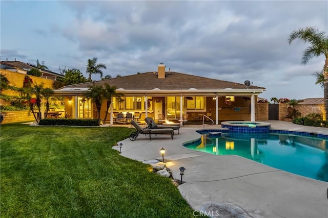 4976 Huntswood Pl, Rancho Cucamonga, CA 91737 - rear view of property with a patio, a fenced backyard, a chimney, a pool with connected hot tub, and an outdoor hangout area