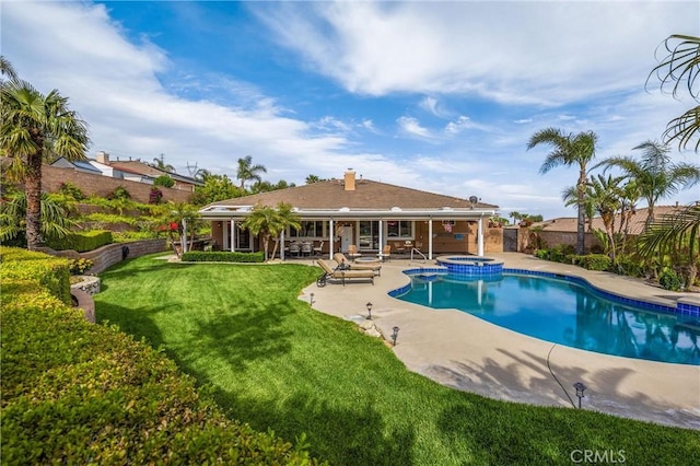 view of pool with a patio and a pool with connected hot tub