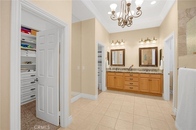full bathroom with a chandelier, ornamental molding, tile patterned floors, a spacious closet, and double vanity