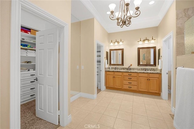 4976 Huntswood Pl, Rancho Cucamonga, CA 91737 - bathroom featuring a chandelier, double vanity, a spacious closet, tile patterned flooring, and crown molding