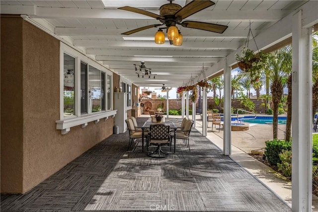 fenced backyard featuring ceiling fan, outdoor dining area, and a patio area