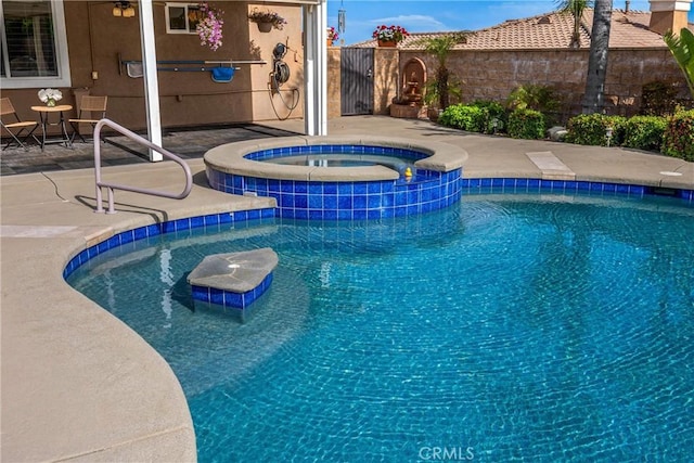 view of pool featuring a pool with connected hot tub, a patio area, and cooling unit