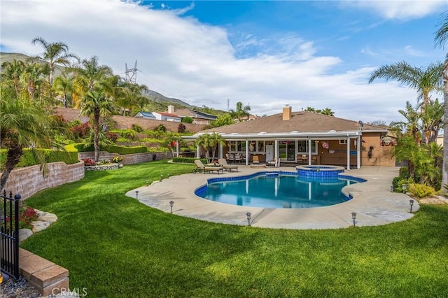 view of swimming pool with a patio and a pool with connected hot tub