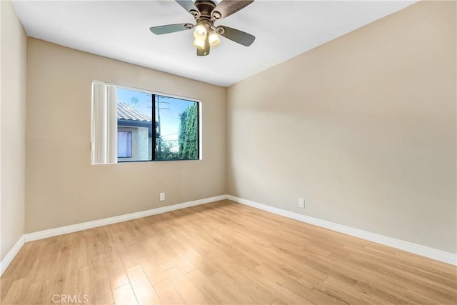 unfurnished room with light wood finished floors, baseboards, and ceiling fan