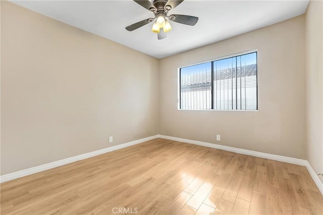unfurnished room featuring baseboards, light wood-style flooring, and a ceiling fan