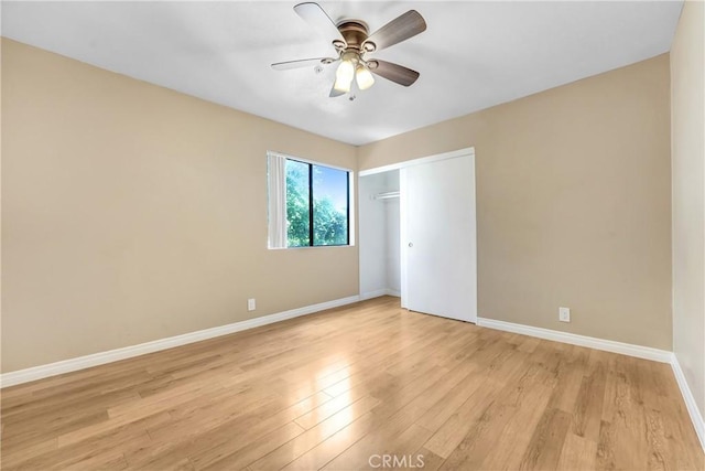 unfurnished bedroom with light wood-type flooring, baseboards, a closet, and ceiling fan