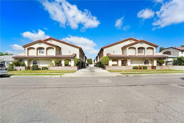 view of front of property with stucco siding and a tile roof