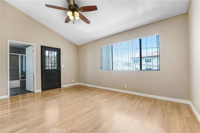 empty room featuring baseboards, a ceiling fan, light wood-type flooring, and lofted ceiling