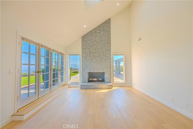26710 Camino Seco, Temecula, CA 92590 - unfurnished living room with high vaulted ceiling, wood finished floors, baseboards, and a stone fireplace