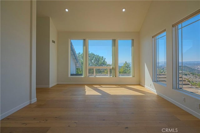 26710 Camino Seco, Temecula, CA 92590 - unfurnished room with plenty of natural light, baseboards, hardwood / wood-style floors, recessed lighting, and lofted ceiling