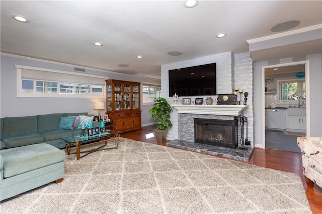 2952 Pemba Dr, Costa Mesa, CA 92626 - living area featuring ornamental molding, wood finished floors, recessed lighting, and a glass covered fireplace