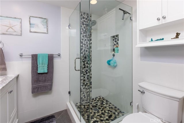 2952 Pemba Dr, Costa Mesa, CA 92626 - bathroom with tile walls, toilet, a shower stall, and vanity