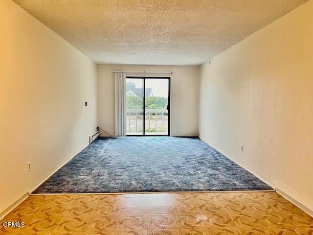 511 Cypress St Unit 4, Fort Bragg, CA 95437 - carpeted spare room with a textured ceiling and a baseboard radiator