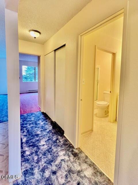511 Cypress St Unit 4, Fort Bragg, CA 95437 - hallway with a textured ceiling, carpet flooring, and baseboard heating