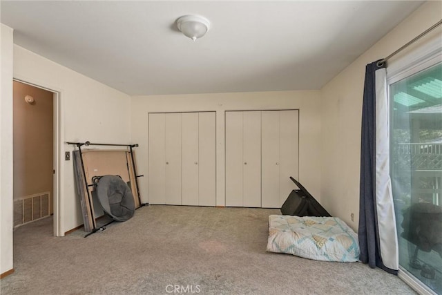 14693 Lafayette Cir, Magalia, CA 95954 - unfurnished bedroom with multiple closets and carpet