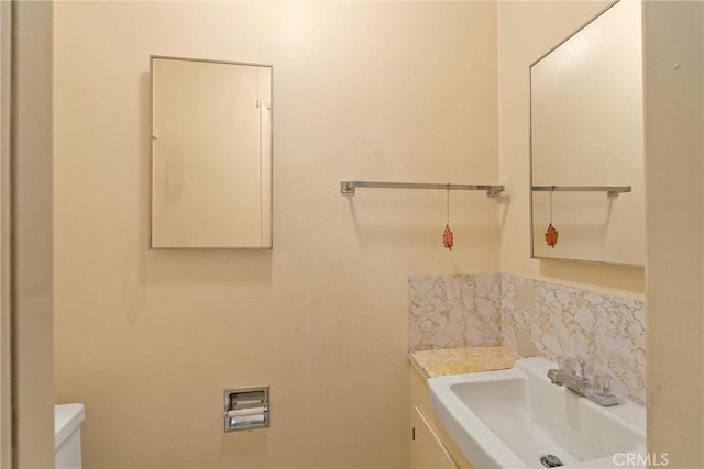 14693 Lafayette Cir, Magalia, CA 95954 - half bathroom with toilet, vanity, and tasteful backsplash