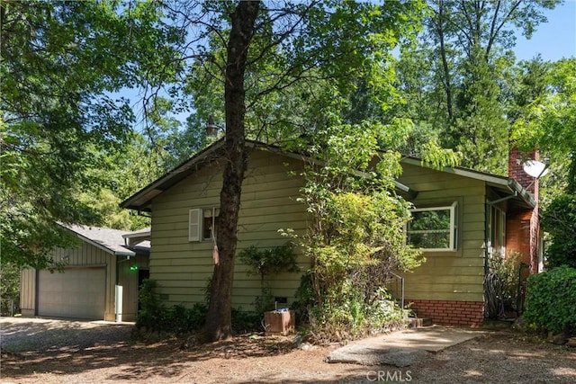 14693 Lafayette Cir, Magalia, CA 95954 - view of side of home with a garage, a chimney, and driveway