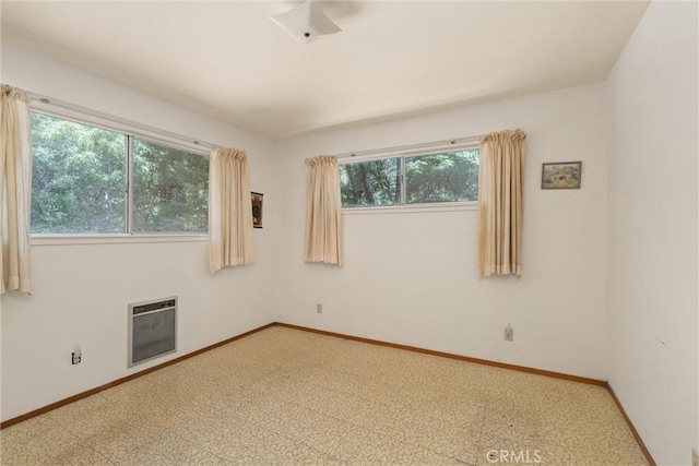 14693 Lafayette Cir, Magalia, CA 95954 - empty room with heating unit, baseboards, and tile patterned floors