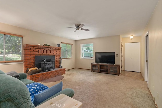 14693 Lafayette Cir, Magalia, CA 95954 - carpeted living area with a wood stove, a ceiling fan, and baseboards