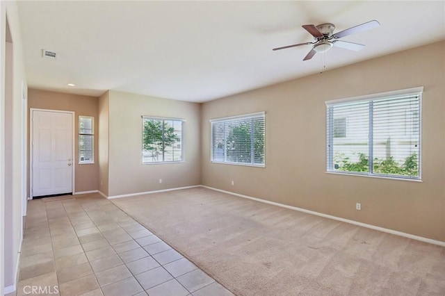 1704 Golden Way, Beaumont, CA 92223 - empty room featuring baseboards, light colored carpet, ceiling fan, and light tile patterned floors
